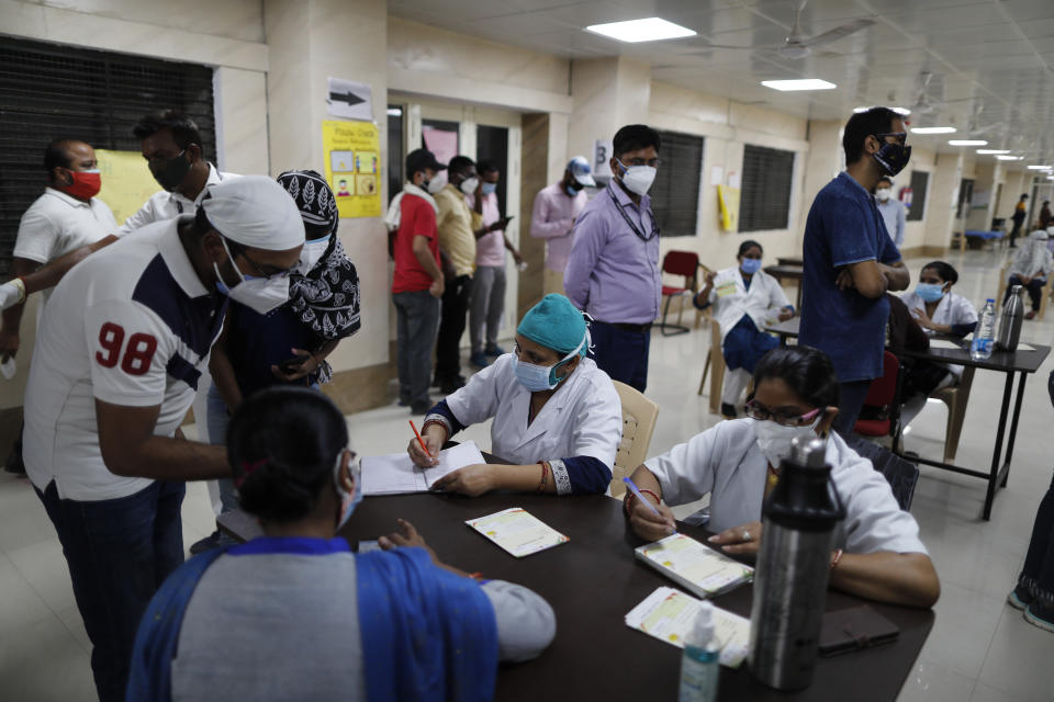 Indians register themselves to receive the vaccine for COVID-19 at a medical college in Prayagraj, India, Saturday, May 8, 2021. Two southern states in India became the latest to declare lockdowns, as coronavirus cases surge at breakneck speed across the country and pressure mounts on Prime Minister Narendra Modi's government to implement a nationwide shutdown. (AP Photo/Rajesh Kumar Singh)