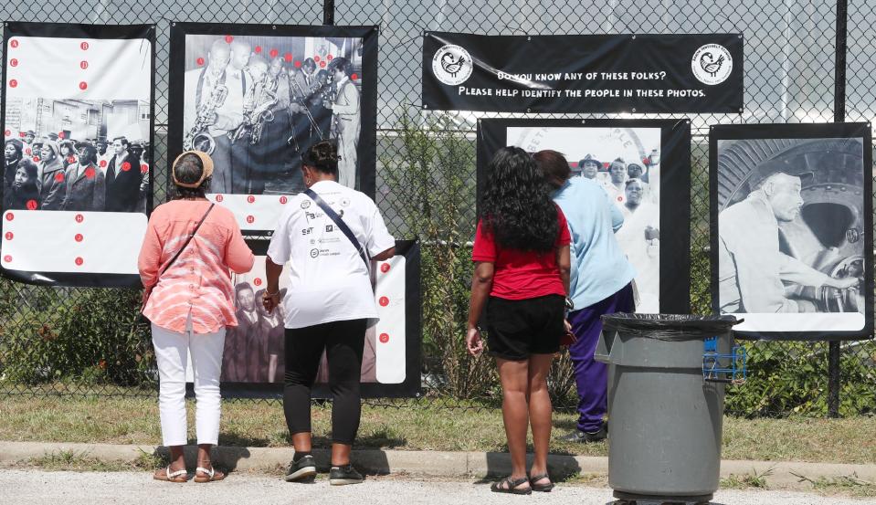 People look at historic photos during the Innerbelt Reunion at the Akron Urban League in Akron on Sunday.