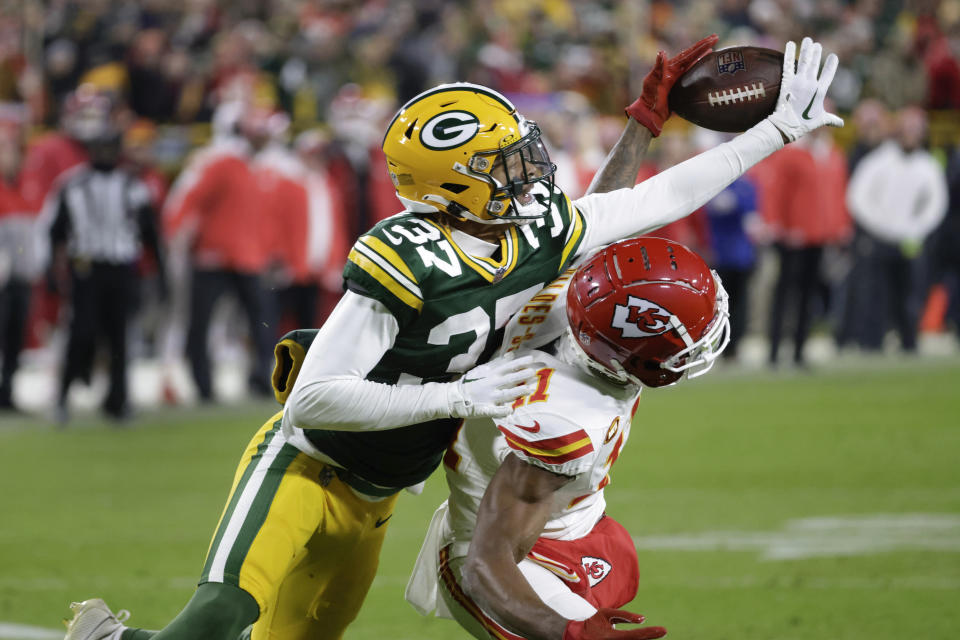 Green Bay Packers cornerback Carrington Valentine (37) breaks up a pass intended for Kansas City Chiefs wide receiver Marquez Valdes-Scantling (11) during the second half of an NFL football game Sunday, Dec. 3, 2023 in Green Bay, Wis. (AP Photo/Mike Roemer)