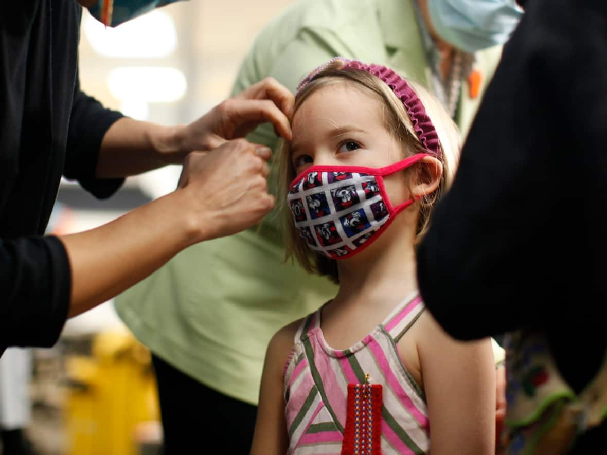 Maeve Fletcher received her first dose of Pfizer's pediatric immunization in Victoria on Nov. 29, 2021. Provincial Health Officer Dr. Bonnie Henry is pictured in the background. The vaccination rate among five- to 11-year-olds in the province is the second lowest in Canada, only ahead of Alberta. (Chad Hipolito/The Canadian Press - image credit)