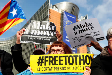 Pro-independence Catalans hold signs as they protest in front of the European Commission headquarters in Brussels, Belgium, February 12, 2019. REUTERS/Francois Lenoir