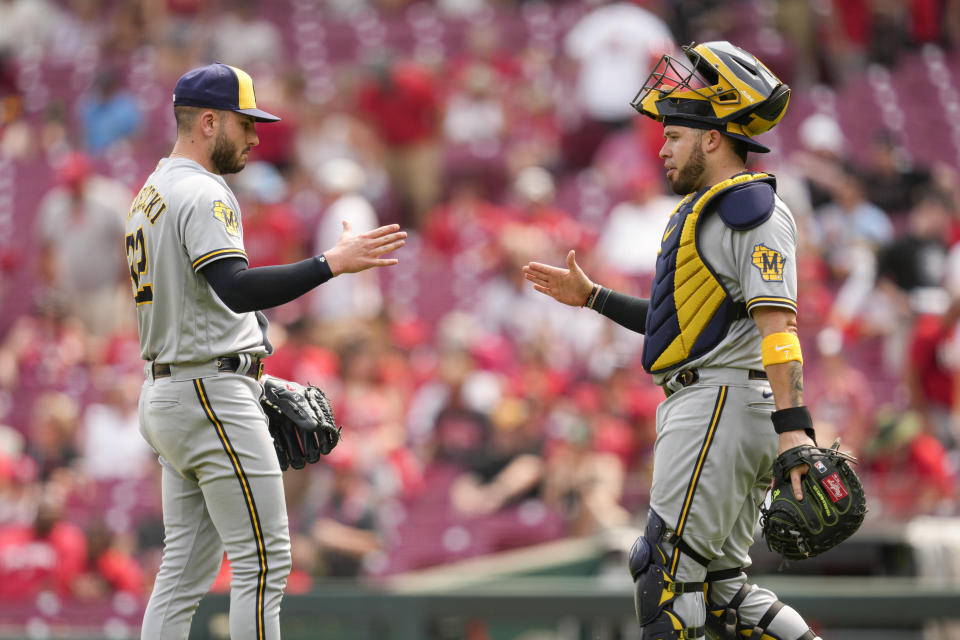 Milwaukee Brewers relief pitcher Peter Strzelecki, left, celebrates with catcher Victor Caratini after a baseball game against the Cincinnati Reds in Cincinnati, Sunday, June 4, 2023. (AP Photo/Jeff Dean)