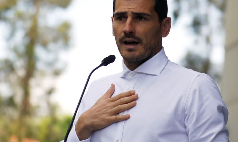 Spanish soccer player Iker Casillas speaks to journalists before he leaves CUF Porto hospital accompanied by his wife Sara Carbonero in Porto