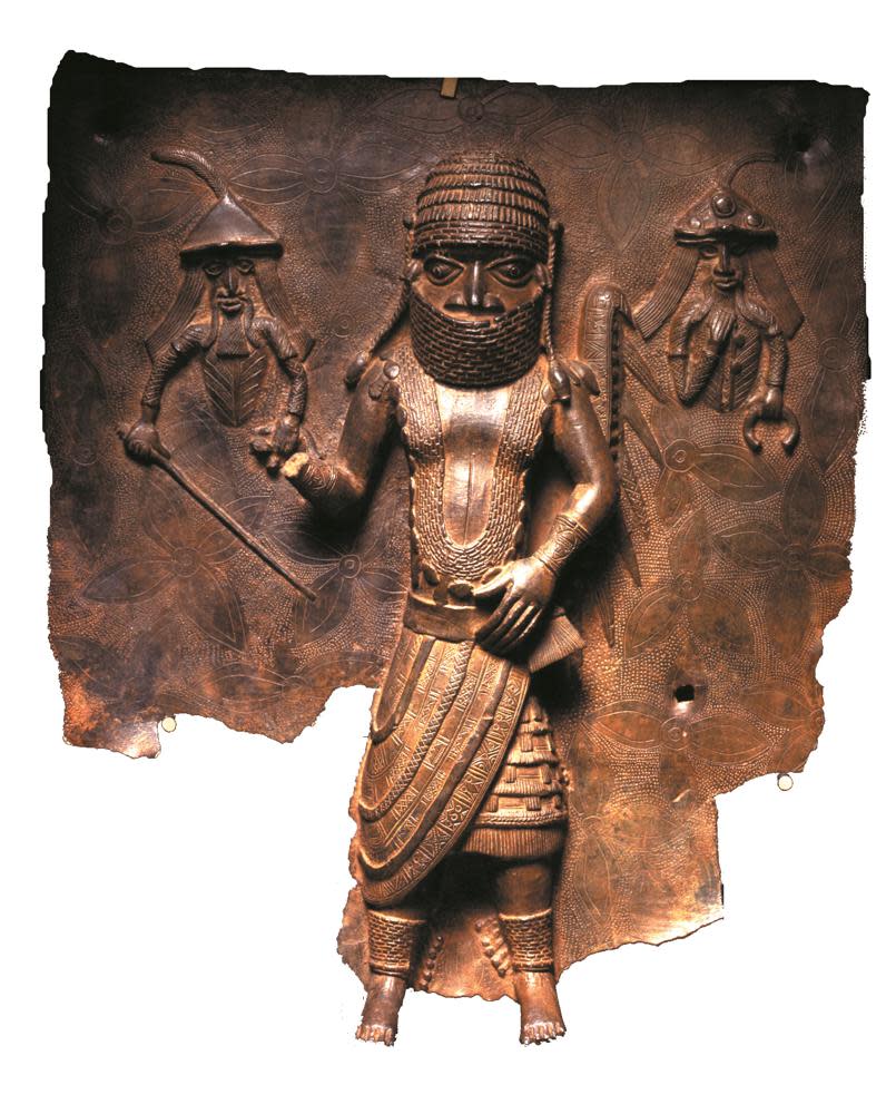 This handout photo provided by Horniman Museum and Gardens shows a Benin copper alloy plaque representing an encounter between Benin Chief Uwangue, and Portuguese traders, who are depicted to his left and right. (Horniman Museum and Gardens via AP)