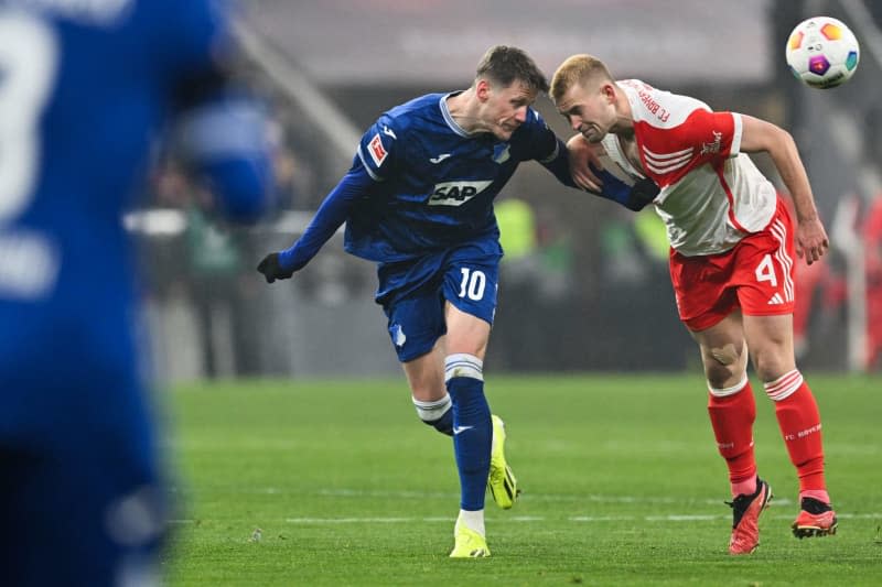 Hoffenheim's Wout Weghorst and Munich's Matthijs de Ligt (R) battle for the ball during the German Bundesliga soccer match between Bayern Munich and TSG 1899 Hoffenheim at the Allianz Arena. Peter Kneffel/dpa