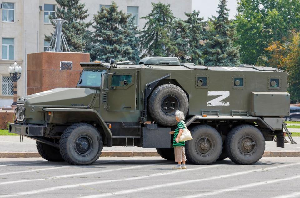 <div class="inline-image__caption"><p>An armored truck of pro-Russian troops is parked near Ukraine's former regional council's building in Kherson.</p></div> <div class="inline-image__credit">Alexander Ermochenko/Reuter</div>