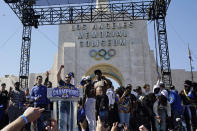 Los Angeles Rams head coach Sean McVay, center-left, raises his fist as he speaks during the Rams' victory celebration at Los Angeles Memorial Coliseum in Los Angeles, Wednesday, Feb. 16, 2022. The Rams beat the Cincinnati Bengals Sunday in the NFL Super Bowl 56 football game. (AP Photo/Marcio Jose Sanchez)