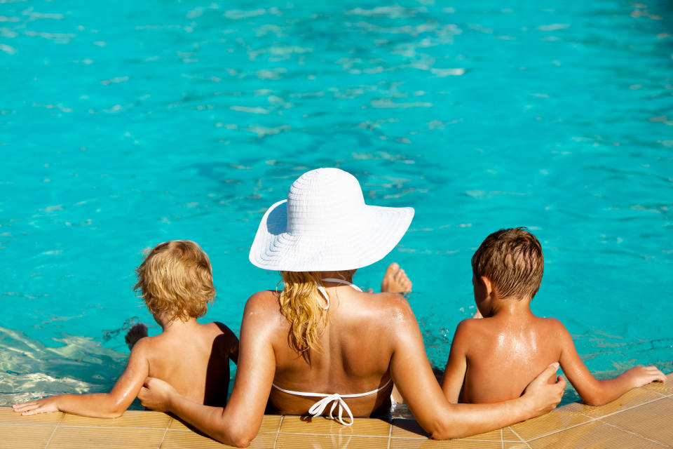 A mum has been called ‘inappropriate’ for sunbaking topless beside a kids’ pool. Photo: Getty Images