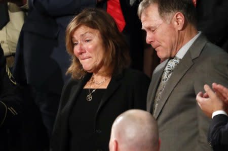 FILE PHOTO: American student Otto Warmbier's parents Fred and Cindy Warmbier cry as U.S. President Donald Trump talks about the death of their son after his arrest in North Korea during the State of the Union address to a joint session of the U.S. Congress on Capitol Hill in Washington, U.S. January 30, 2018. REUTERS/Leah Millis