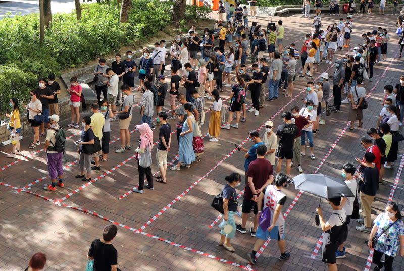 Voters queue up to vote during primary elections aimed for selecting democracy candidates, in Hong Kong