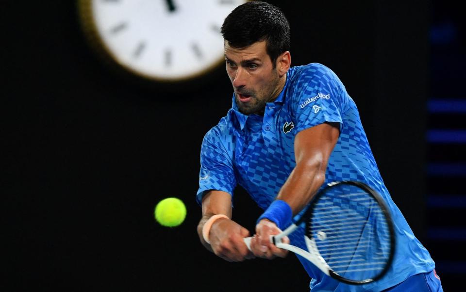 Serbia's Novak Djokovic hits a return against Spain's Roberto Carballes Baena during their men's singles match on day two of the Australian Open - Paul Crock/Getty Images