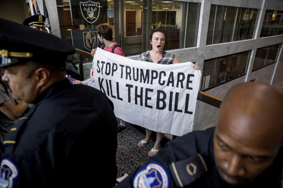 Capitol Hill police officers prepare to arrest a group protesting the Republican healthcare bill outside the offices of Sen. Dean Heller, R-Nev., on Capitol Hill in Washington, Monday, July 17, 2017. The Senate has been forced to put the republican’s health care bill on hold for as much as two weeks until Sen. John McCain, R-Ariz., can return from surgery. (AP Photo/Andrew Harnik)