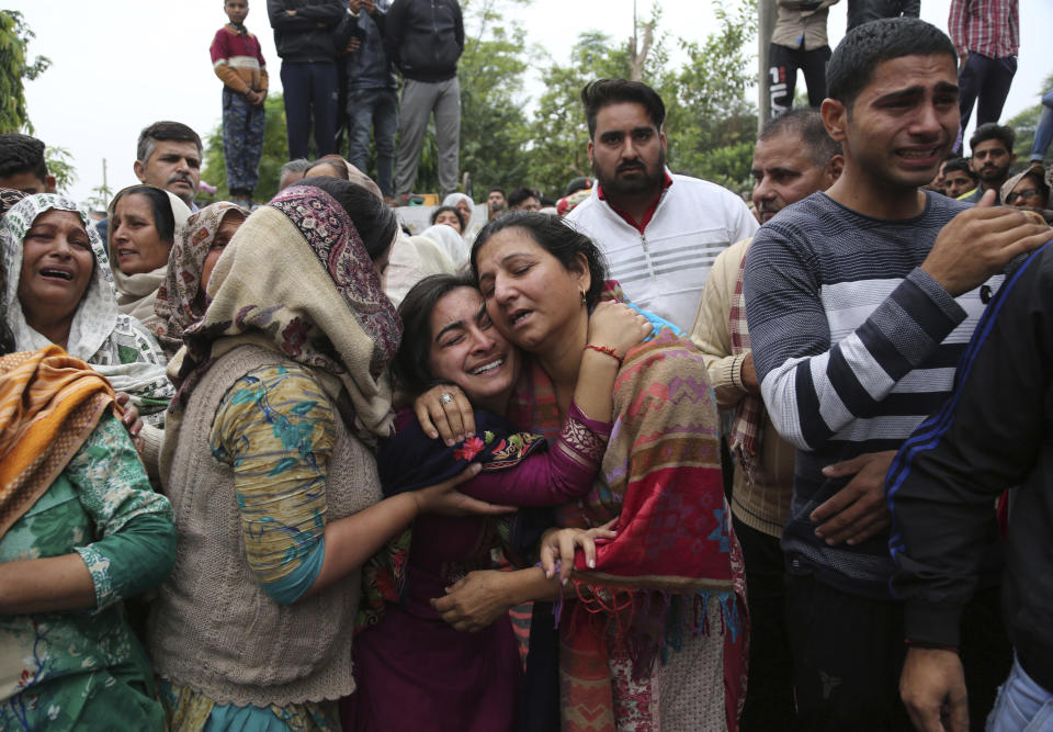 In this Nov. 11, 2018, file photo, family members and villagers grieve and console each other as the body an Indian Army soldier Varun Katal is brought to his house before the cremation in village Mawa in Samba district, 62 kilometers (51 miles) from Jammu, India. An Indian soldier was killed when Pakistani soldiers fired at Indian positions along the highly militarized frontier in disputed Kashmir on Saturday, Indian military said. (AP Photo/Channi Anand, File)