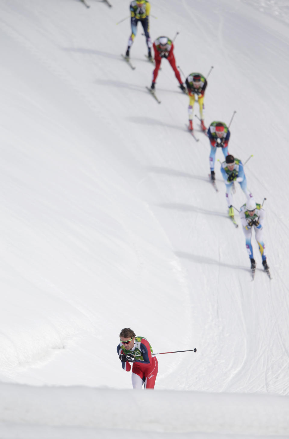 Norway's Petter Northug is followed by his competitors during the men's cross-country team sprint final at the 2014 Winter Olympics, Wednesday, Feb. 19, 2014, in Krasnaya Polyana, Russia.