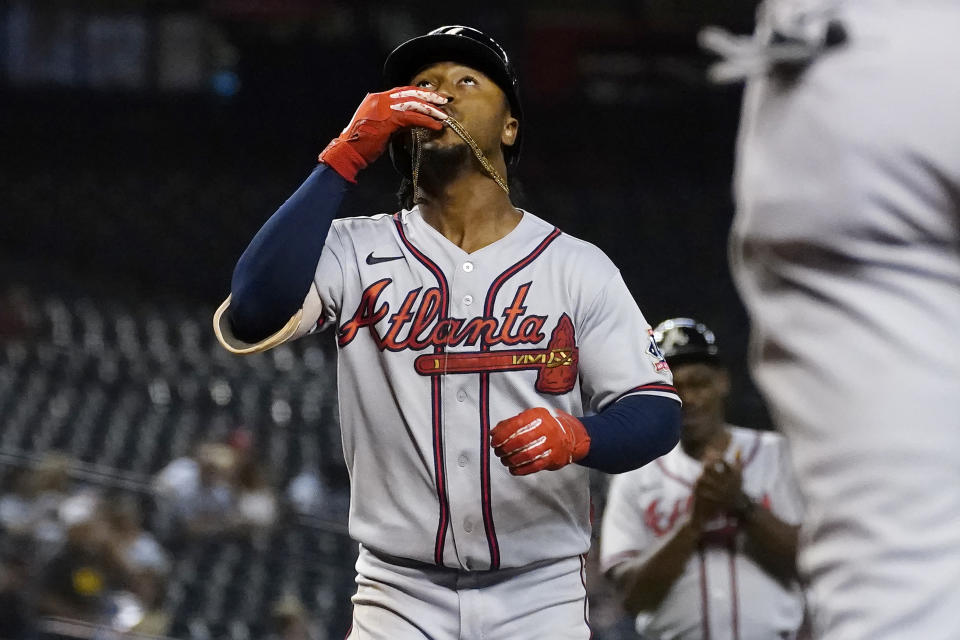 Atlanta Braves' Ozzie Albies celebrates his solo home run against the Arizona Diamondbacks during the third inning of a baseball game, Tuesday, Sept. 21, 2021, in Phoenix. (AP Photo/Matt York)