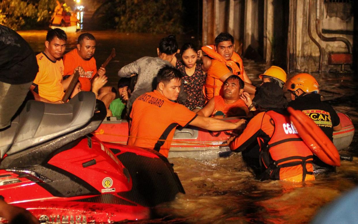 Rescue workers evacuate flood-affected residents in Davao on the southern Philippine island of Mindanao - AFP