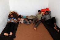 Afghan refugees are pictured on September 22, 2013 at an UNHCR centre in Herat after being deported from Iran