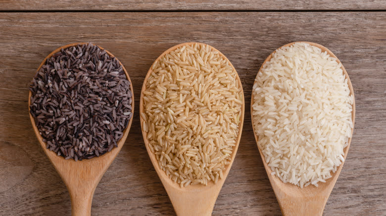 three types of rice in spoons