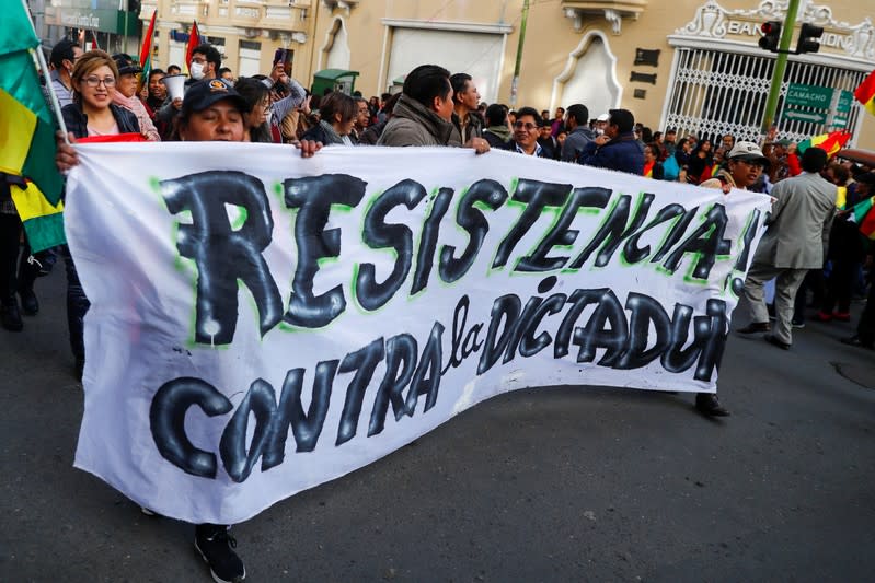 Opponents of Bolivia's President Evo Morales hold a banner reading "Resistance against dictatorship" during a protest, in La Paz