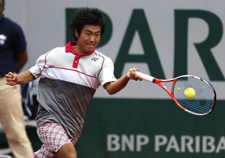 Yoshihito Nishioka of Japan plays a shot to Tomas Berdych of the Czech Republic during their men's singles match at the French Open tennis tournament at the Roland Garros stadium in Paris, France, May 25, 2015. REUTERS/Pascal Rossignol