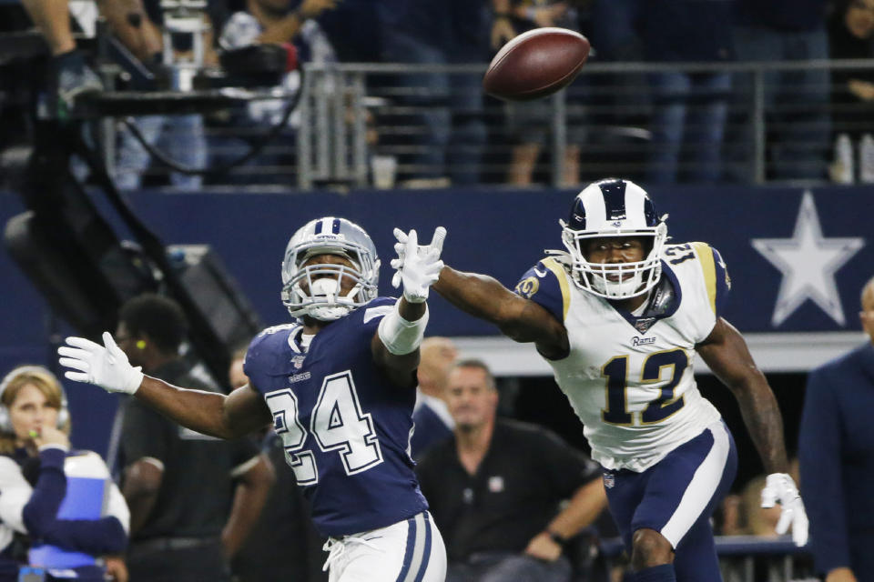 Dallas Cowboys cornerback Chidobe Awuzie (24) and Los Angeles Rams wide receiver Brandin Cooks (12) reach for the ball in the second half of an NFL football game in Arlington, Texas, Sunday, Dec. 15, 2019. (AP Photo/Michael Ainsworth)