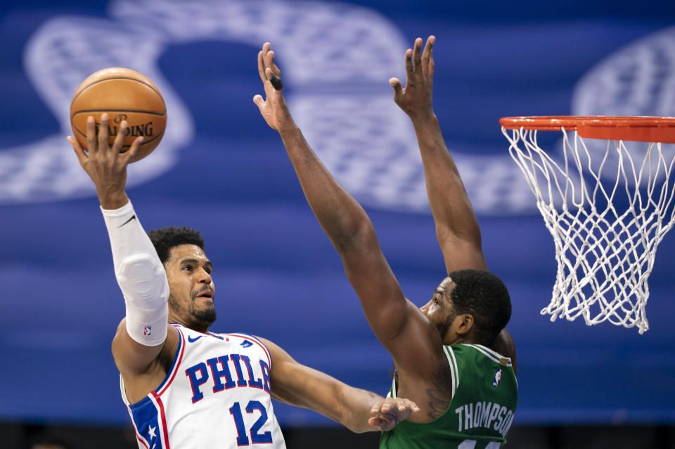 Philadelphia 76ers forward Tobias Harris, left, goes up for a shot against Boston Celtics forward Tristan Thompson during the first half of an NBA basketball game Wednesday, Jan. 20, 2021, in Philadelphia. (AP Photo/Chris Szagola)