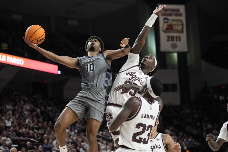 Oral Roberts guard Issac McBride (10) goes up to make a basket as Texas A&M guard Manny Obaseki, top right, defends during the second half of an NCAA college basketball game Friday, Nov. 17, 2023, in College Station, Texas. (AP Photo/Sam Craft)