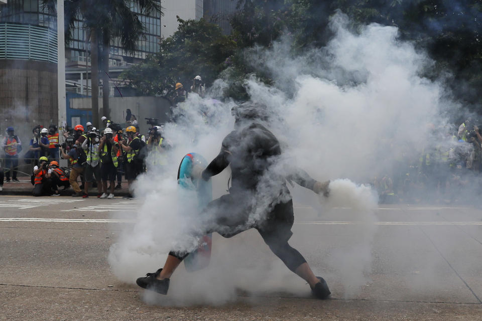A protester throws a tear gas round back at police during the demonstration in Hong Kong, Sept. 29, 2019. (Photo: Kin Cheung/AP)
