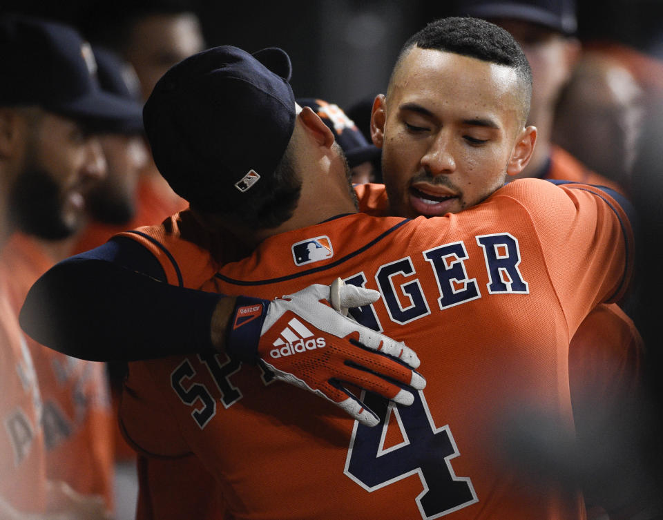 Houston Astros' Carlos Correa, right, hugs George Springer after hitting a solo home run off Los Angeles Angels starting pitcher Jaime Barria during the third inning of a baseball game Friday, Sept. 20, 2019, in Houston. (AP Photo/Eric Christian Smith)