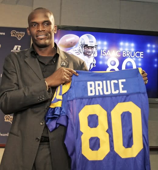 St. Louis Rams' Isaac Bruce holds up his jersey number