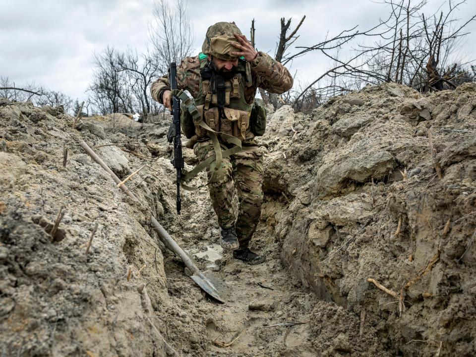 Ukrainian medic "Doc" with the 28th Brigade runs through a partially dug trench along the frontline on March 05, 2023 outside of Bakhmut, Ukraine.