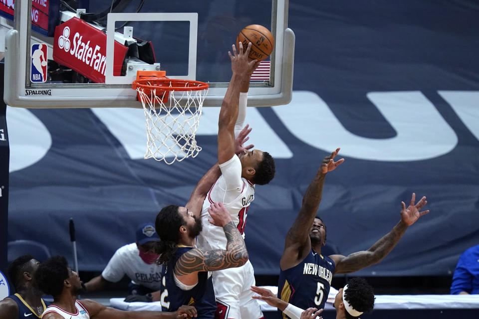 Chicago Bulls center Daniel Gafford goes to the basket between New Orleans Pelicans guard Eric Bledsoe (5) and center Steven Adams during the first half of an NBA basketball game in New Orleans, Wednesday, March 3, 2021. (AP Photo/Gerald Herbert)