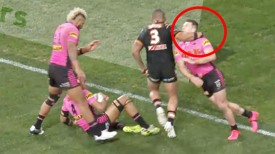 A screenshot shows the moment Wests Tigers star Joey Leilua hits Penrith's Dylan Edwards.