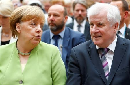 FILE PHOTO: German Chancellor Angela Merkel and German Interior minister Horst Seehofer attend an event to commemorate victims of displacement in Berlin, Germany, June 20 2018. REUTERS/Hannibal Hanschke/File Photo