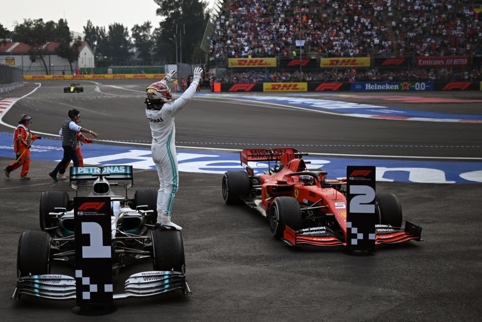 Mercedes' British driver Lewis Hamilton celebrates after winning the F1 Mexico Grand Prix, at the Hermanos Rodriguez racetrack in Mexico City on October 27, 2019. - Lewis Hamilton won the Mexican Grand Prix on Sunday, but will have to wait for his sixth world title after Mercedes teammate Valtteri Bottas came home in third. (Photo by PEDRO PARDO / AFP) (Photo by PEDRO PARDO/AFP via Getty Images)