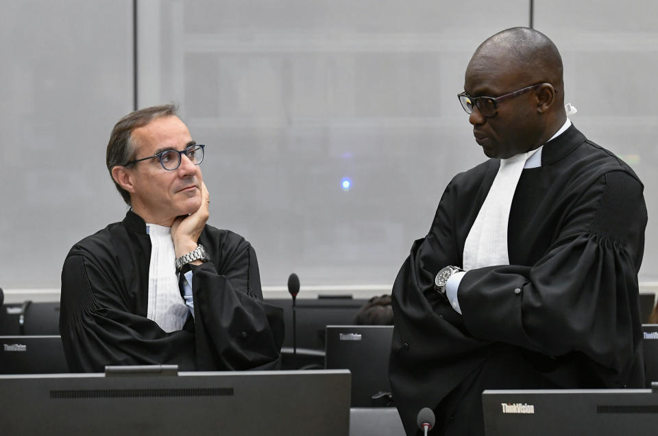 Prosecutors Gilles Dutertre, left, and Mame Mandiaye Niang attend the trial of Al Hassan Ag Abdoul Aziz Ag Mohamed Ag Mahmoud, a Malian rebel accused of policing a brutal Islamic regime in the Malian city of Timbukti after rebels overran the historic desert city in 2012, at the International Criminal Court in The Hague, Netherlands, Monday May 9, 2022. (Piroschka van de Wouw/Pool via AP)