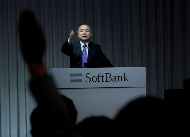 FILE PHOTO: A journalist raises her hand to ask a question to Japan's SoftBank Group Corp Chief Executive Masayoshi Son during a news conference in Tokyo