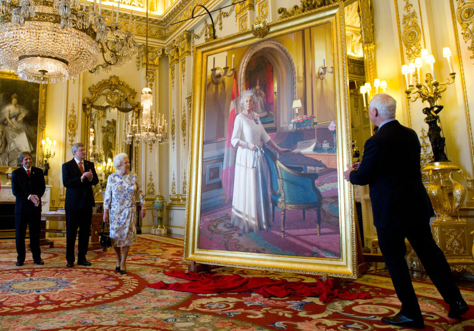 Canadian artist Phil Richards (left) and former Canadian Prime Minister Stephen Harper (2nd left) stood with Queen Elizabeth II as she unveiled a portrait of herself in the white drawing room at Buckingham Palace as former Governor General David Johnston (right) watches on June 6, 2012 in London, England. (Photo by Sean Kilpatrick - WPA Pool /Getty Images)