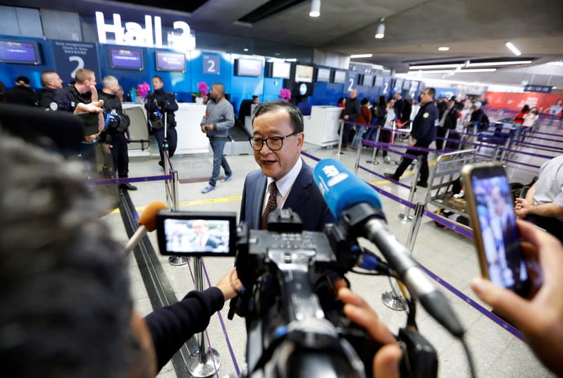 Cambodia's self-exiled opposition party founder Sam Rainsy, who has vowed to return to his home country, talks to the media after being prevented from checking-in for a flight from Paris to Bangkok at Roissy Airport in Paris