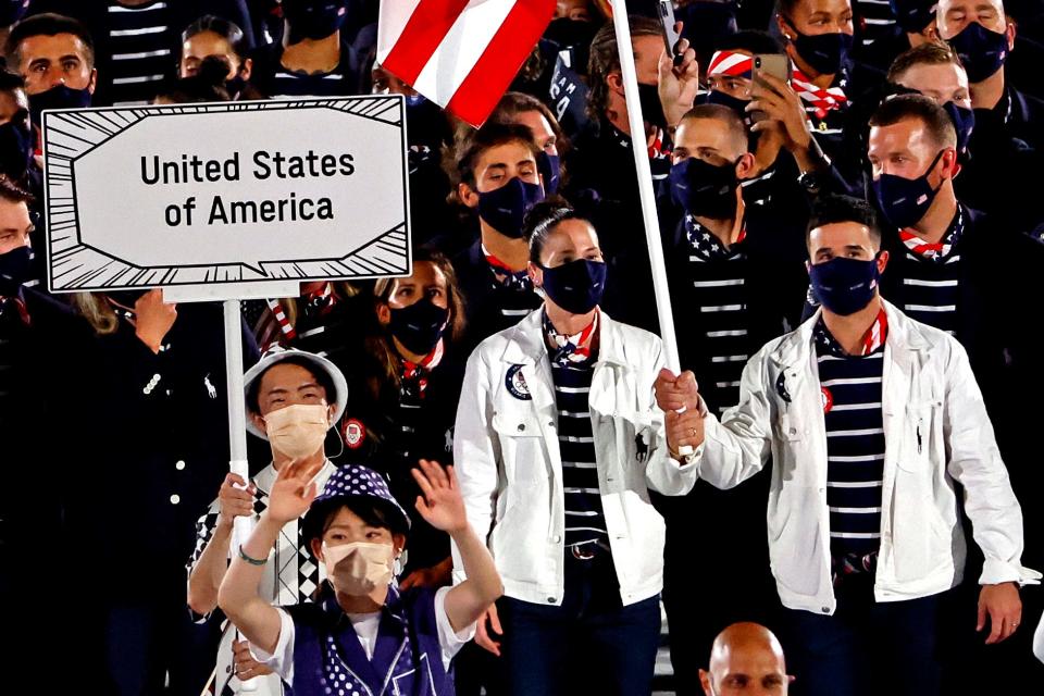 Sue Bird and Eddy Alvarez carry the flag for the United States on July 23, 2021, during the opening ceremony for the Tokyo 2020 Olympic Summer Games at Olympic Stadium.