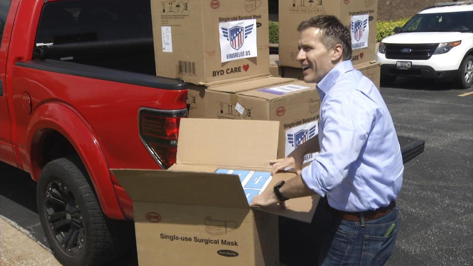 In this April 27, 2020 image from video provided by KRCG-TV, former Missouri Gov. Eric Greitens delivers masks to first responders in Columbia, Mo. Greitens passed out masks across the state in the early days of the coronavirus pandemic last spring. (KRCG-TV via The AP)