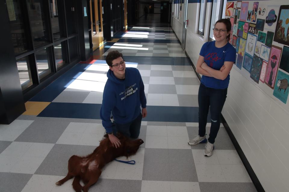 Charlie, the Adrian school district's police and therapy dog, rolls over for a belly rub from sophomore Noah Judson, pictured with his sister, sophomore Claire Judson, Feb. 7 at Adrian High School. The Tecumseh City Council on Monday approved an amendment to its school resource officer agreement with the Tecumseh schools to allow their SRO to have a dog like Charlie.