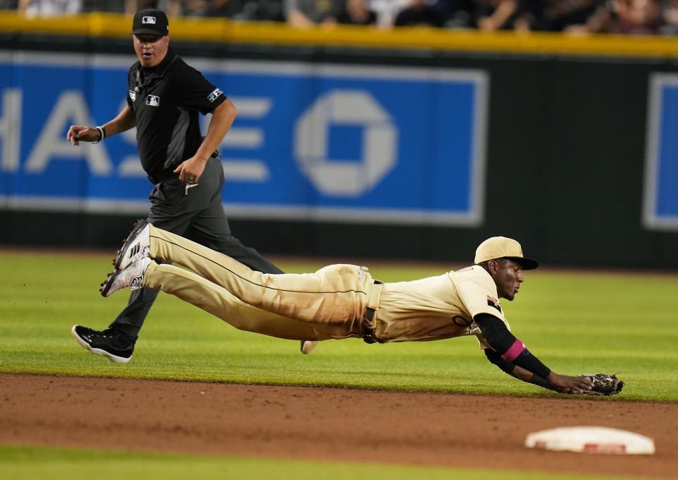 Aug 5, 2022; Phoenix, Ariz., USA. Arizona Diamondbacks shortstop Geraldo Perdomo makes a diving stop against the Colorado Rockies at Chase Field on Friday, Aug. 5, 2022.