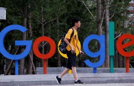 FILE PHOTO: A man walks past the brand logo of Alphabet Inc's Google outside its office in Beijing, China, August 8, 2018.  REUTERS/Thomas Peter