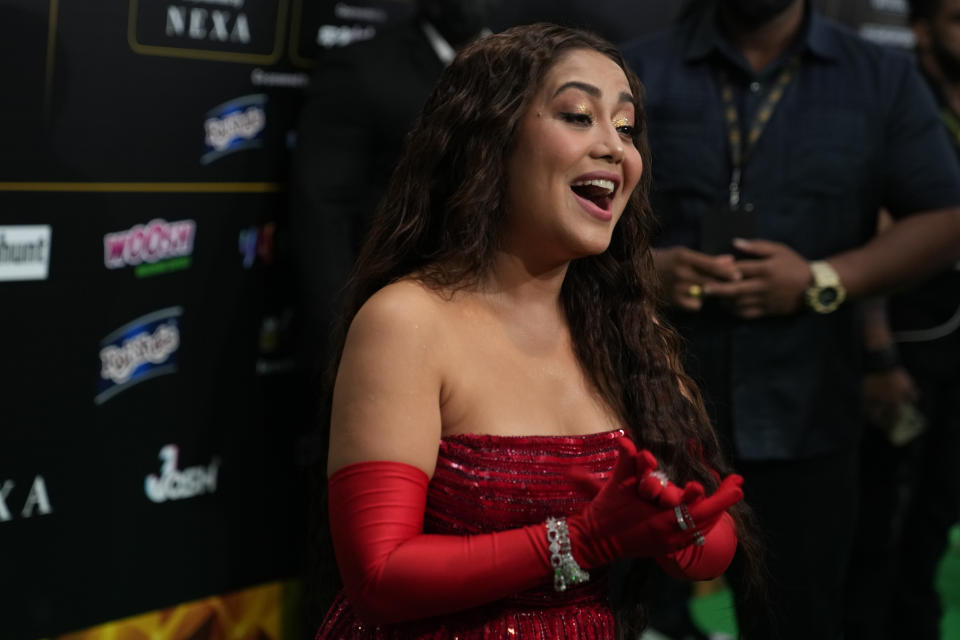 Indian singer Neha Kakkar poses on the green carpet ahead of the 22nd International Indian Film Academy (IIFA) awards in Abu Dhabi, United Arab Emirates, Friday, June 3, 2021. (AP Photo/Kamran Jebreili)