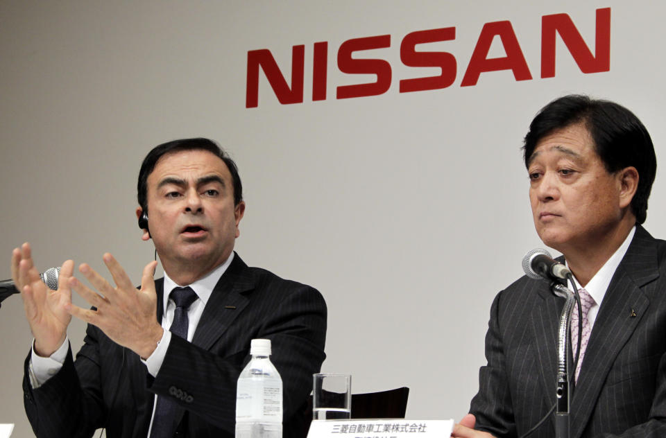 FILE - In this this Dec. 14, 2010 file photo, then Nissan Motor Co. President and CEO Carlos Ghosn, left, speaks as then Mitsubishi Motors Corp. President Osamu Masuko looks on during their joint press conference in Tokyo. The arrest of Nissan’s former chief executive Ghosn has raised doubts over the future of the alliance among automakers Nissan, Renault and Mitsubishi Motors that he helped forge. Such alliances wax and wane over time, but have grown in importance as companies develop electric vehicles, net connectivity and artificial intelligence for autos.(AP Photo/Koji Sasahara, File)