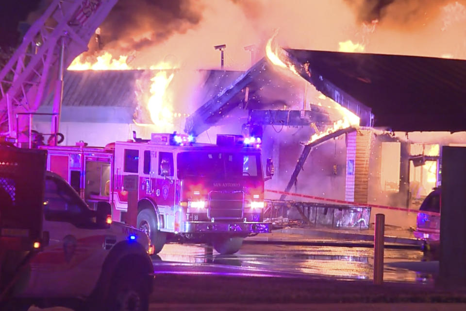 In this image taken from a video provided by KSAT-TV, flames rise from a truck stop in San Antonio, Texas, early Thursday morning, Dec. 1, 2022. (KSAT-TV via AP)