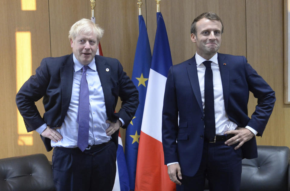 Britain's Prime Minister Boris Johnson poses with French President Emmanuel Macron, right, during a European Union leaders summit in Brussels, Belgium, Thursday Oct. 17, 2019. Britain and the European Union reached a new tentative Brexit deal on Thursday, hoping to finally escape the acrimony, divisions and frustration of their three-year negotiation. (Johanna Geron/Pool via AP)