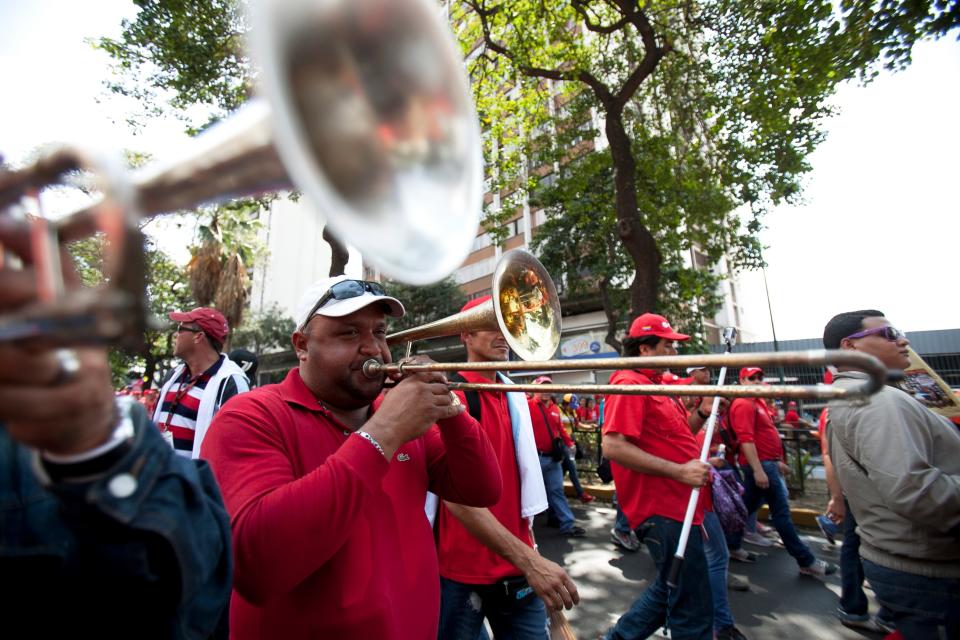 Employees of Petroleos de Venezuela, PDVSA, play music during a pro government march in Caracas, Venezuela, Tuesday, Feb. 18, 2014. The Venezuelan government accuses the Obama administration of siding with student protesters it has blamed for violence that led to three deaths last week. Maduro claims the U.S. is trying to stir up unrest to regain dominance of South America's largest oil producer.(AP Photo/Alejandro Cegarra)