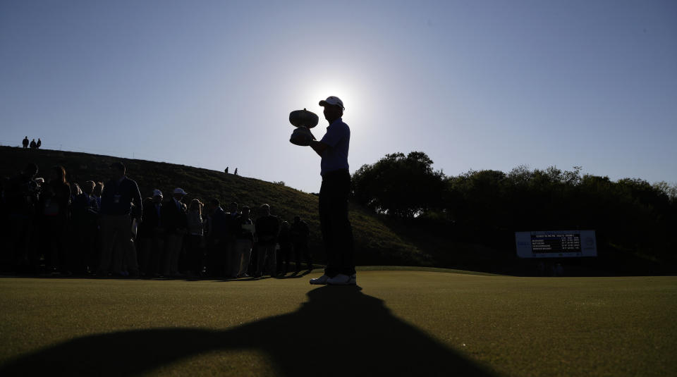 Kevin Kisner poses with his trophy after he defeated Matt Kuchar in the finals at the Dell Technologies Match Play Championship golf tournament, Sunday, March 31, 2019, in Austin, Texas. (AP Photo/Eric Gay)